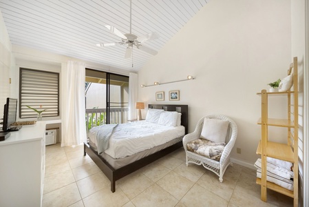 Relax in a serene space featuring high ceilings, cozy decor, and direct lanai access—ideal for unwinding after beach days.