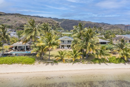 Aerial view of the beach and nearby lush landscaping, highlighting the tropical paradise.