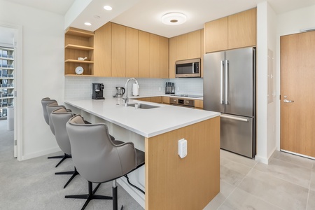 Modern kitchen with sleek appliances and a breakfast bar.