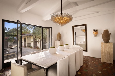 Host unforgettable meals beneath a sculptural chandelier, with a Carrara marble table and handcrafted ceramics in quiet sophistication.