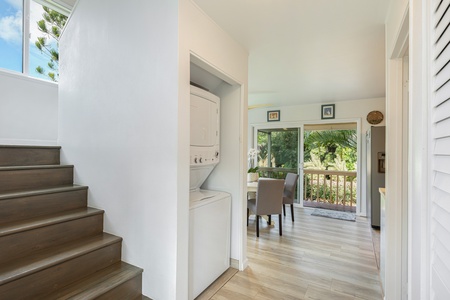 Interior stairs lead to the upstairs bedrooms, with washer/dryer and dining space nearby.