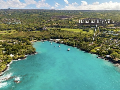 Aerial view of Hahalua Bay Villa's stunning coastal location, nestled among lush tropical landscapes with turquoise waters and pristine bay access.