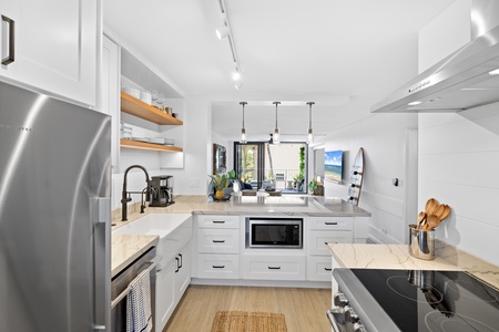 Delight in this sleek, fully equipped kitchen with ample counter space and bright, contemporary design.