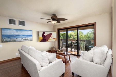 Living room with plush sectional seating and large windows offering garden views.