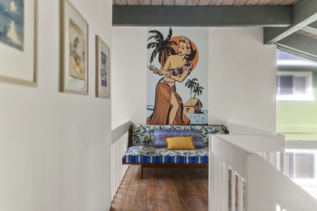 Vibrant island mural adds a fun and artistic touch to this inviting upstairs lounge.