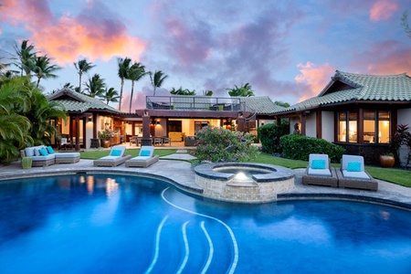 Beach Walker: Beautiful circular pool surrounded by lush greenery and comfortable lounge chairs, offering a perfect spot to relax and enjoy the outdoors.