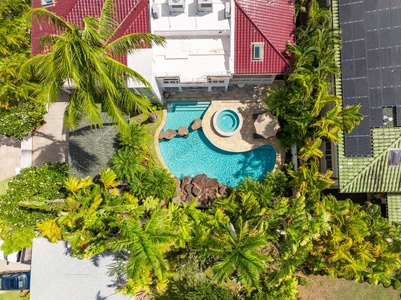 Aerial view of the lush pool area surrounded by tropical gardens, offering a serene, private oasis.