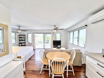 The guest cottage offers a king bed, pull-out sofa, full bath, lanai, wet bar, and brand-new air conditioning.