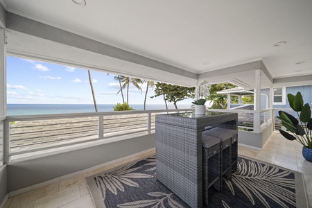 Unwind in our elevated upper-level lanai, boasting a bar-style seating and stunning beachfront vistas.