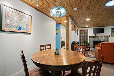 A colorful pendant light adds ambiance to the space where guests connect over dinner or conversation.