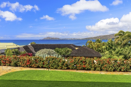 Fragrant foliage and vibrant flowers frame sweeping blue-water views.
