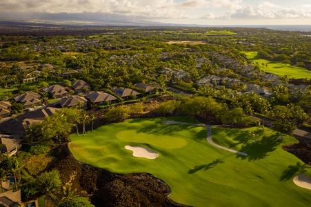 Home situated on Mauna Lani North Course 11th pin, tucked back into private tropical screening while not inhibiting the vista views from the home.