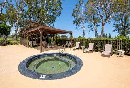 Soak in the soothing jacuzzi at Pool B beneath a shaded pergola—perfect after beach days or golf rounds.