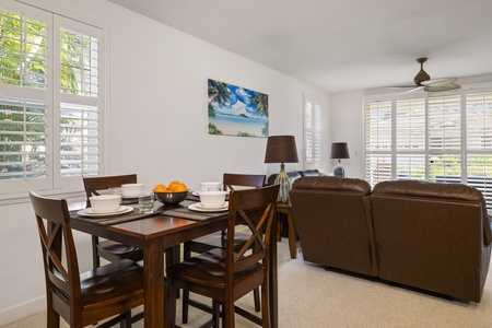 Gather for meals, conversation, or movie nights in the bright living and dining space designed for easy island living.
