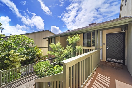 Tropical greenery frames the entry, a quiet welcome at the end of the coast road.