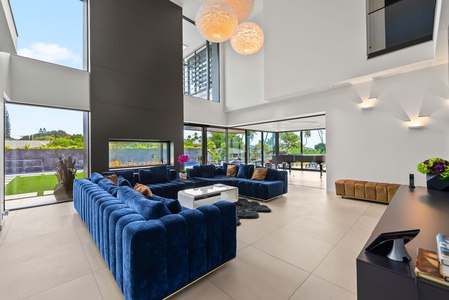 Relax in the two-story living space with plush seating and walls of glass.