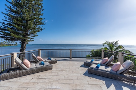 Ocean views and sunshine in private yard with lounge area.