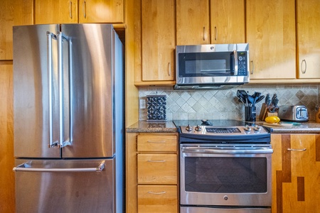 The kitchen offers modern appliances and ocean views, making meal preparation a breeze while enjoying the stunning scenery.