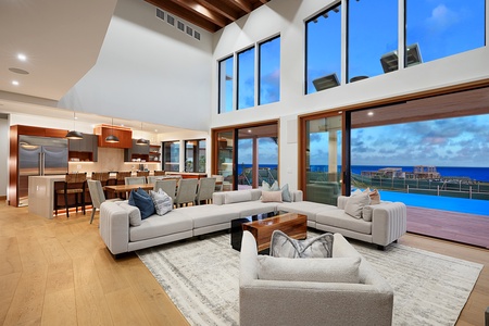 Gather around the high-ceiling living area with large glass windows and open and airy ambiance.