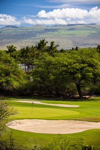 Peaceful views of the Mauna Lani fairways framed by lush forested ridges.