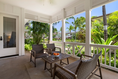 Covered lanai with deep seating and lush landscaping—your own quiet retreat at the edge of paradise.