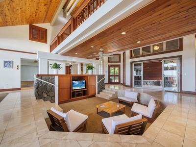 Cozy sunken living space with wood accents and modern amenities for family entertainment.  