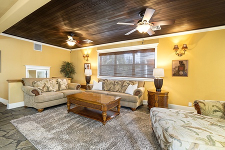 Media room features a plush sectional, central A/C, and ample seating for movie nights.