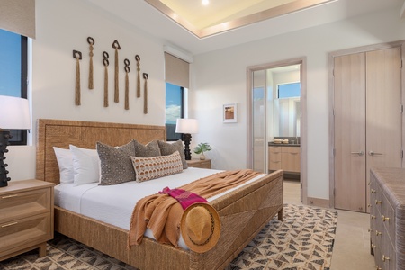 The guest bedroom exudes warmth and comfort, featuring a stylish bed.