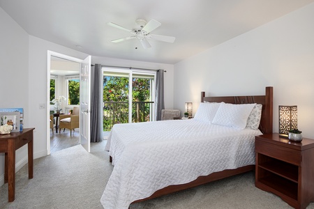 Downstairs primary suite features a king bed, seating area, and patio access.