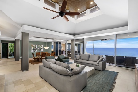 Unwind in your expansive living space with panoramic ocean views stretching endlessly beyond floor-to-ceiling windows.