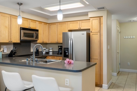 Enjoy a morning coffee at the kitchen island/bar, equipped with modern appliances and plenty of storage.