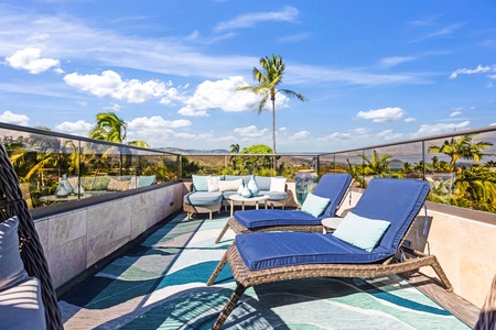 Lounge chairs on the rooftop deck with mountain views.