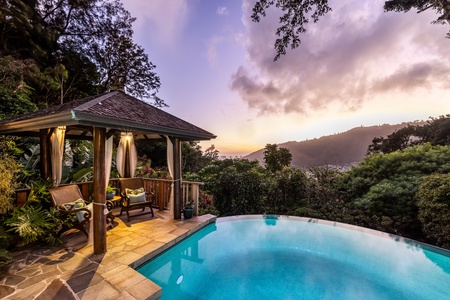 Evening magic by the pool—relax under the gazebo as twilight sets the tone.