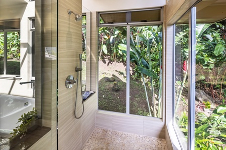 Tropical garden views from the spa-inspired shower—connect with nature as you refresh and unwind.