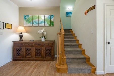 Grand staircase leading to the upper-level bedrooms, adding a touch of charm to the entryway.