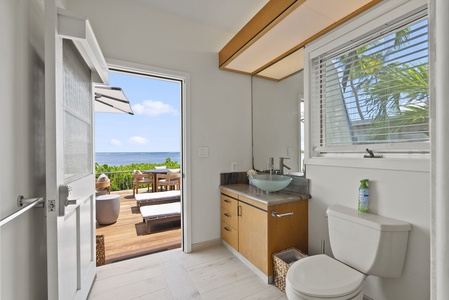 Convenient poolside bath at Wailupe Beachfront Getaway with direct access to the ocean-view deck