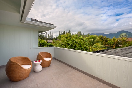 Cozy seating on a shaded outdoor patio with mountain views.