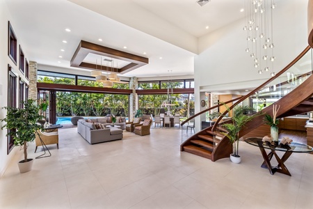 Grand living area with high ceilings and seamless indoor-outdoor flow.