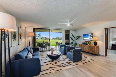 Relax in the airy living room with plush seating and sliding doors that open to golf course views and ocean breezes.