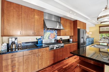 Well-appointed kitchen with rich wooden cabinetry and all the essentials for preparing family meals.