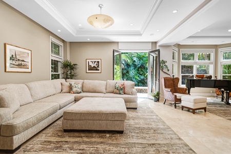 Lower-level living room with sectional and garden access.