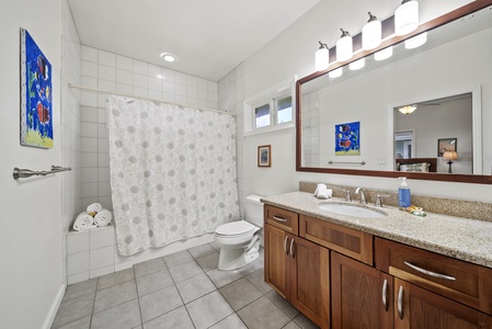 Full bathroom with modern fixtures, granite vanity, and shower/tub combo—ideal for convenience and comfort during your stay.