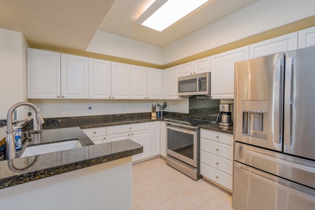 Fully-stocked kitchen with wide counter space and ample cabinetry for your culinary adventures.