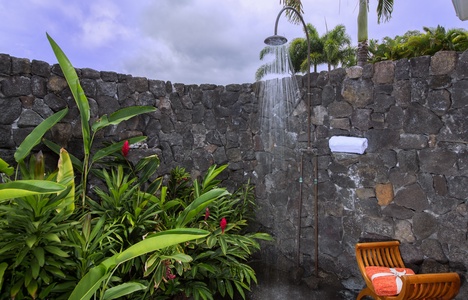 Rinse off under the stars in this tropical stone-walled outdoor shower—pure island luxury.