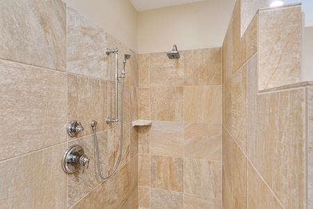 Refresh in the luxurious walk-in shower of Kona Blue Vacations Holua Kai’s primary suite bathroom.
