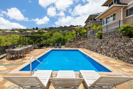 Multiple lounge chairs surround the pool deck, giving everyone their own sunny space to relax, unwind, or take in the view.