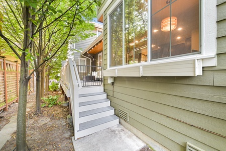 Access the retreat easily via the shaded back stairway surrounded by lush greenery.