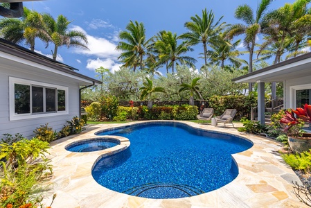 Palm trees and blue water create the perfect backyard escape.