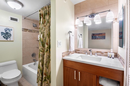 Ensuite bathroom with tub and vanity for added convenience.