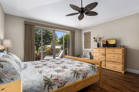 Rest easy in the serene primary suite at Kona Blue Vacations Holua Kai, complete with a king-size bed.